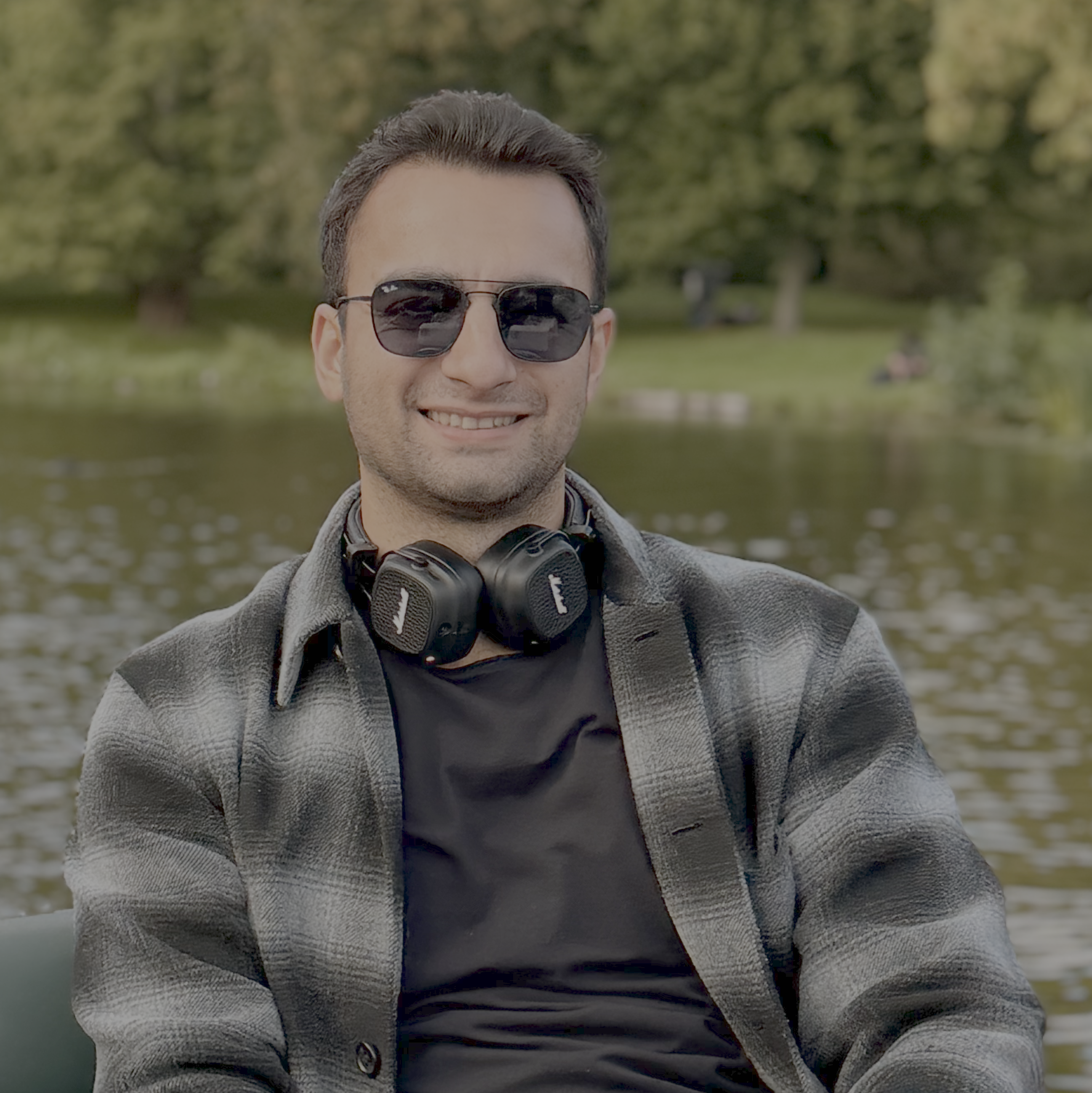 Matin Amanullahi wearing sunglasses and headphones around his neck